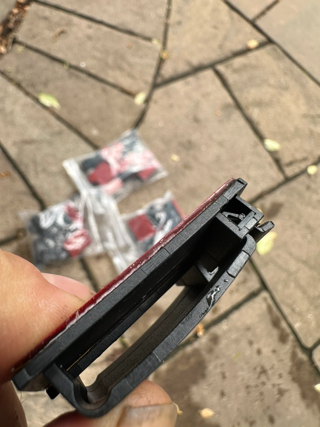 Black plastic clips with adhesive backing
