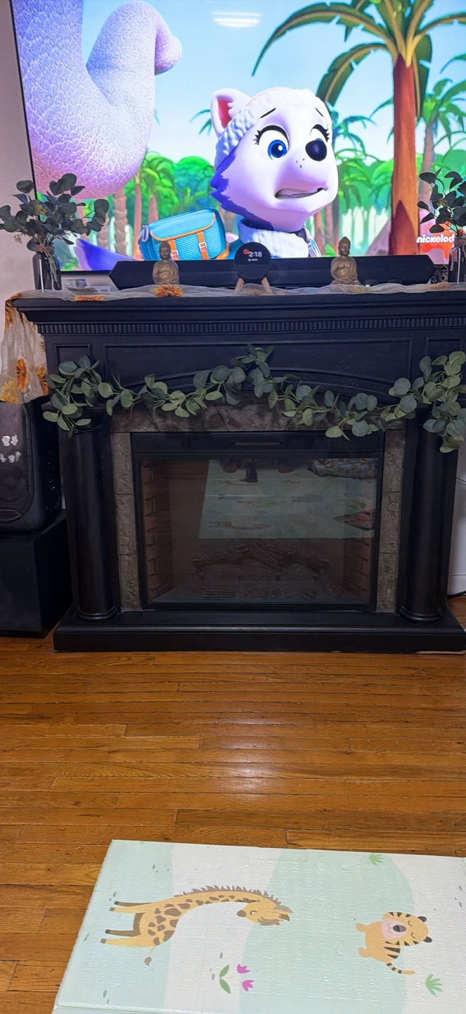 Black Faux Fireplace with Decorative Garland