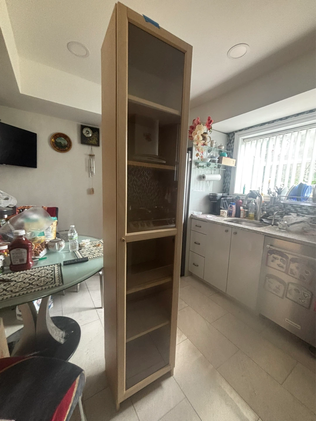 Tall display cabinet with glass door