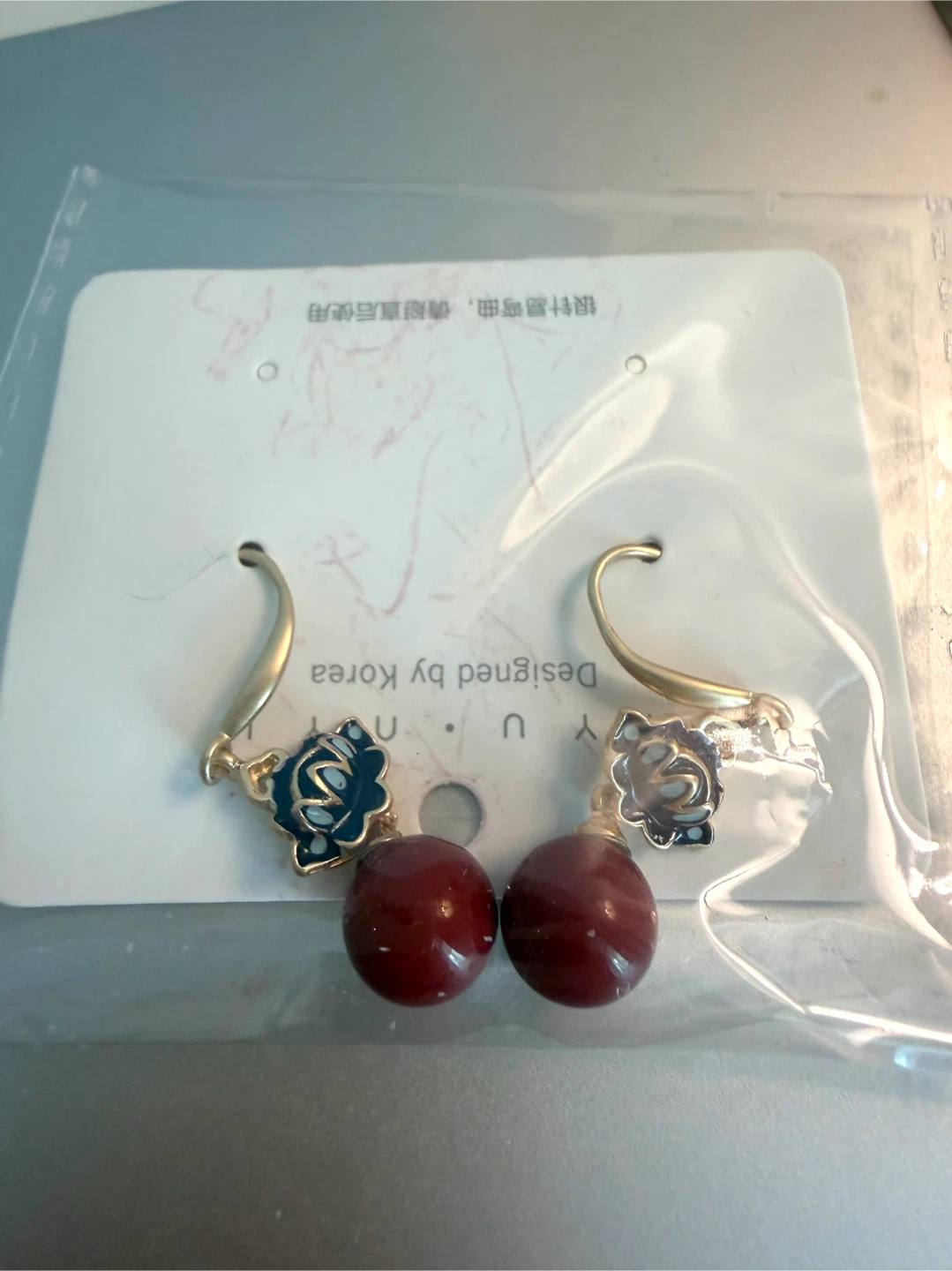 Gold Tone Earrings with Red Beads and Blue Flower Accents