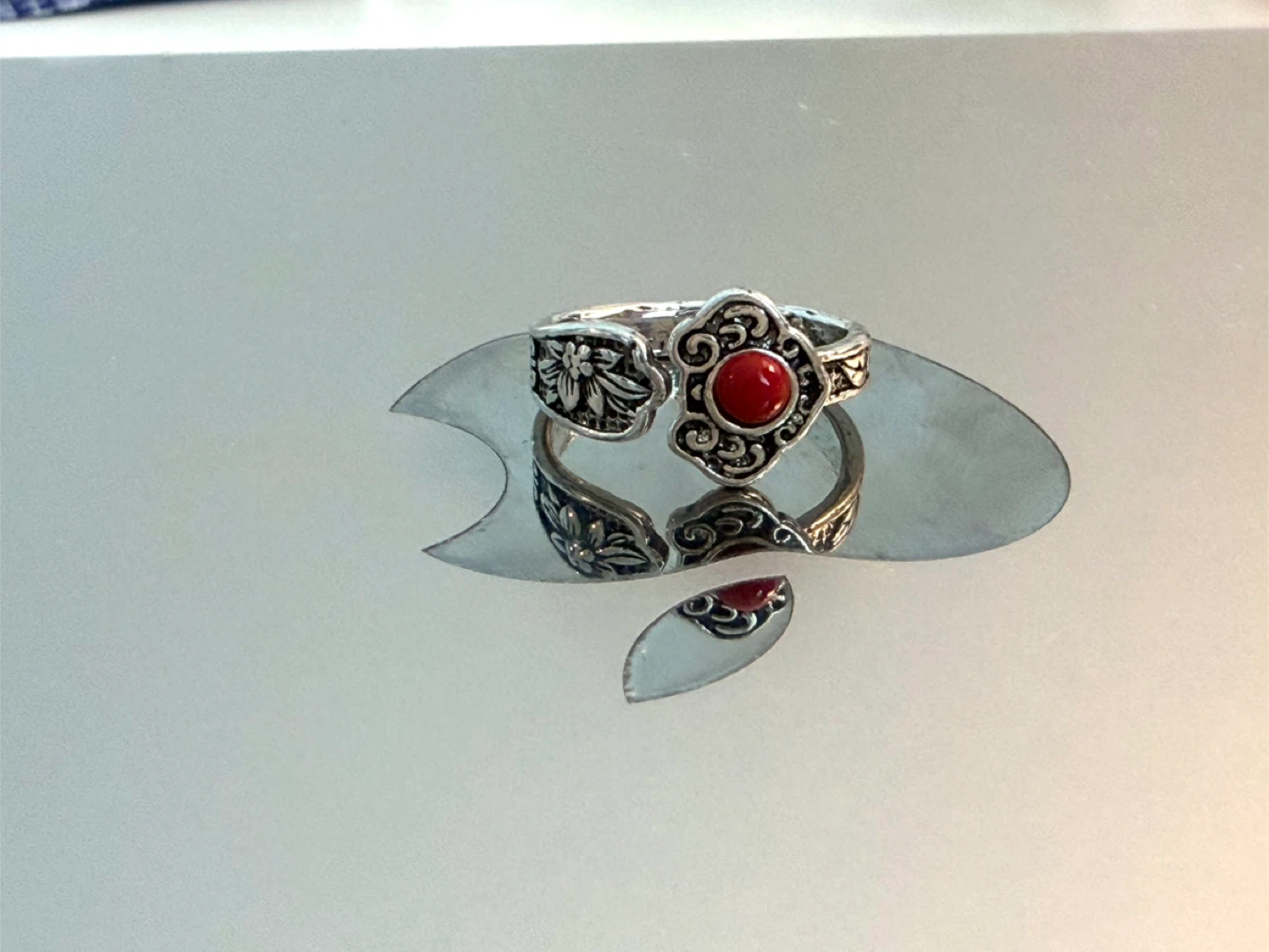 Silver-tone ring with red stone accent