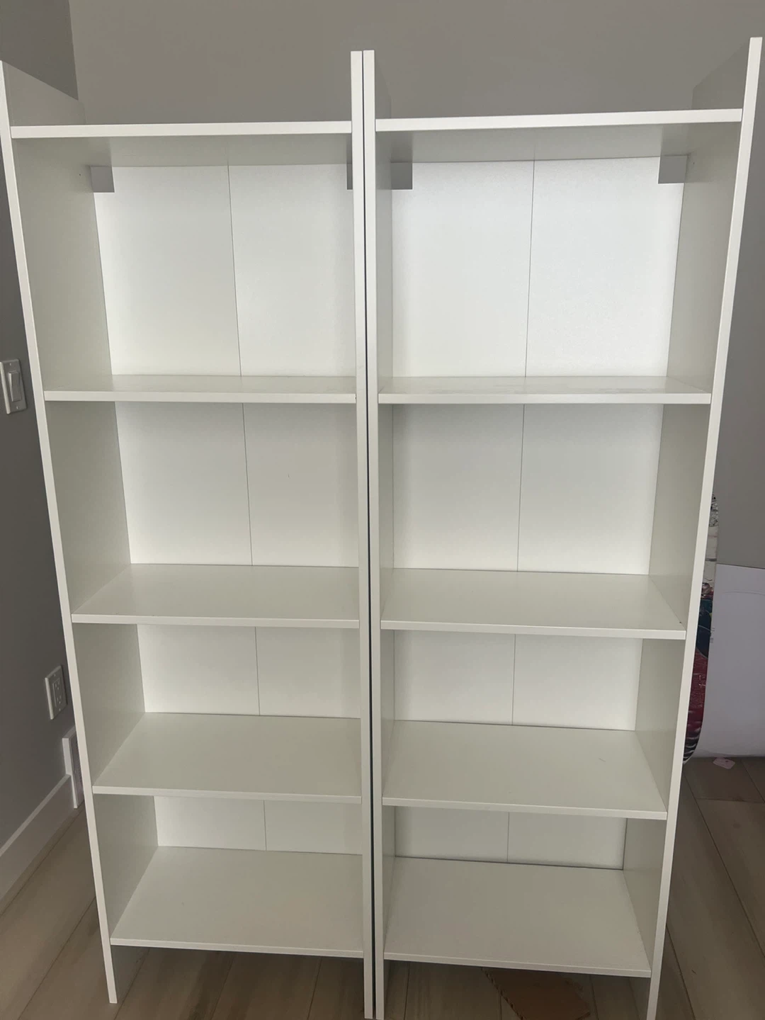 Two White Ikea BAGGEBO Bookshelves