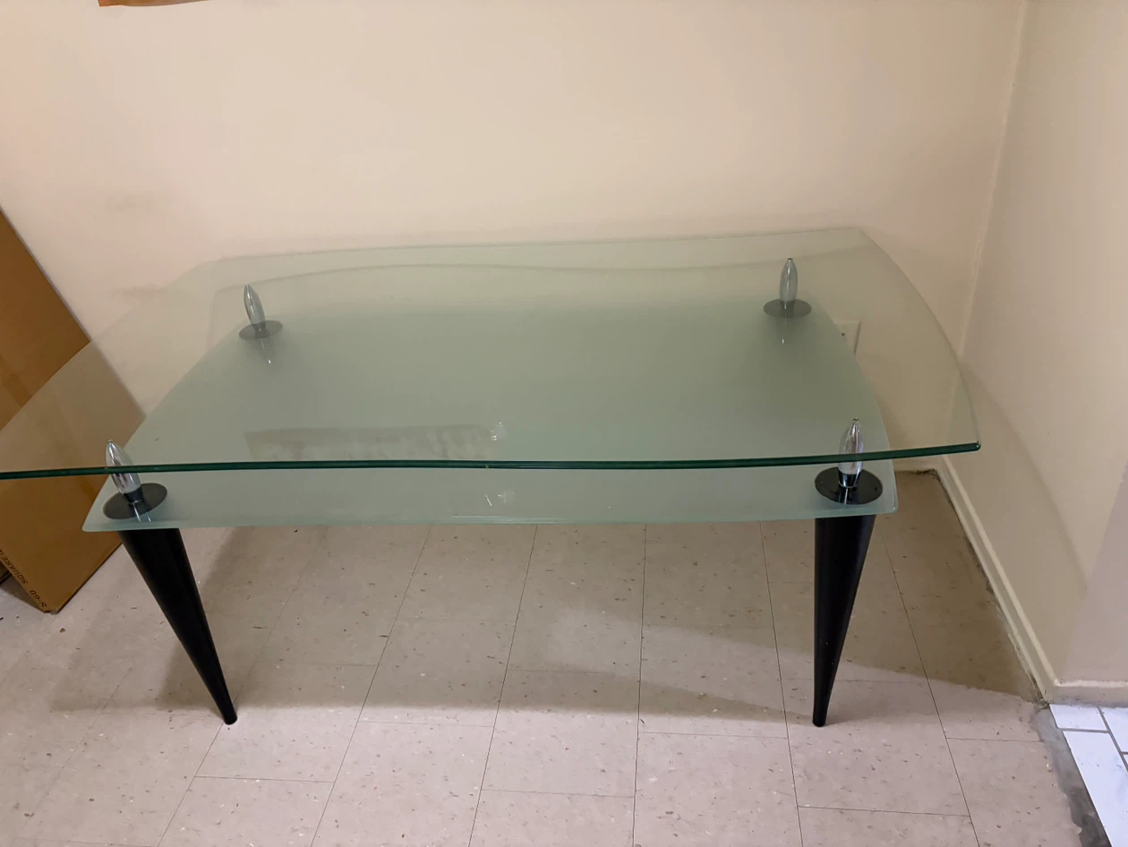 Glass top dining table with black legs