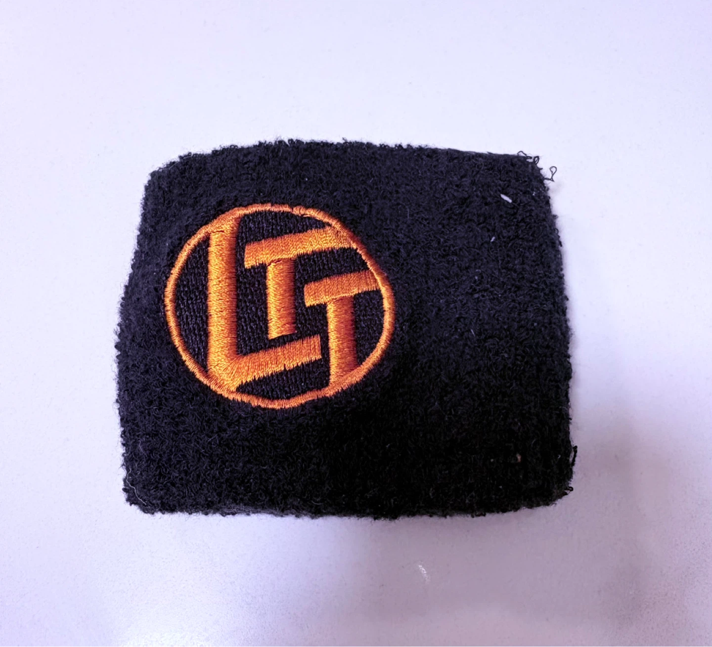 Black Wristband with Orange Logo