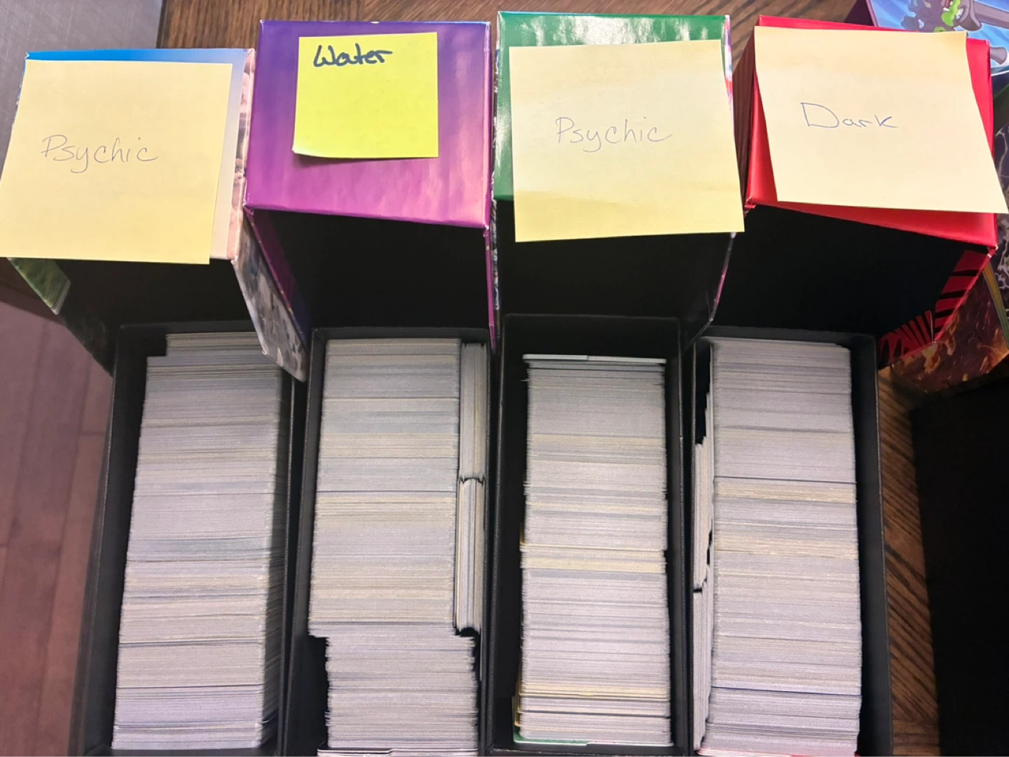 Pokémon ETB boxes with various common cards