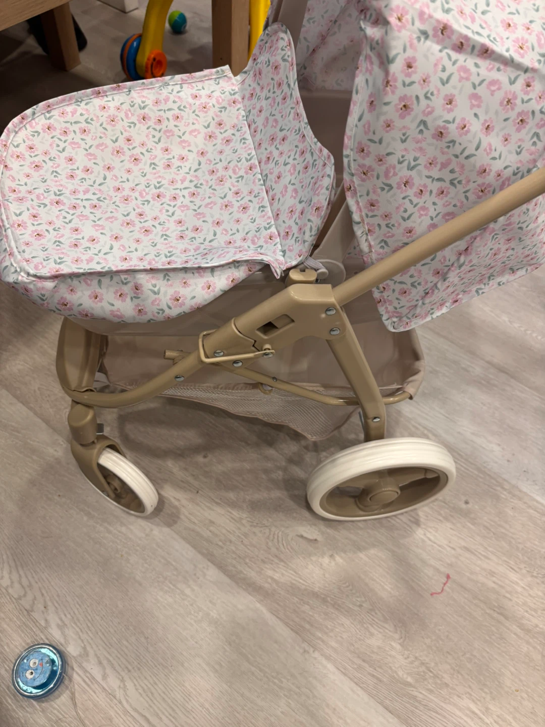 Doll stroller with floral print