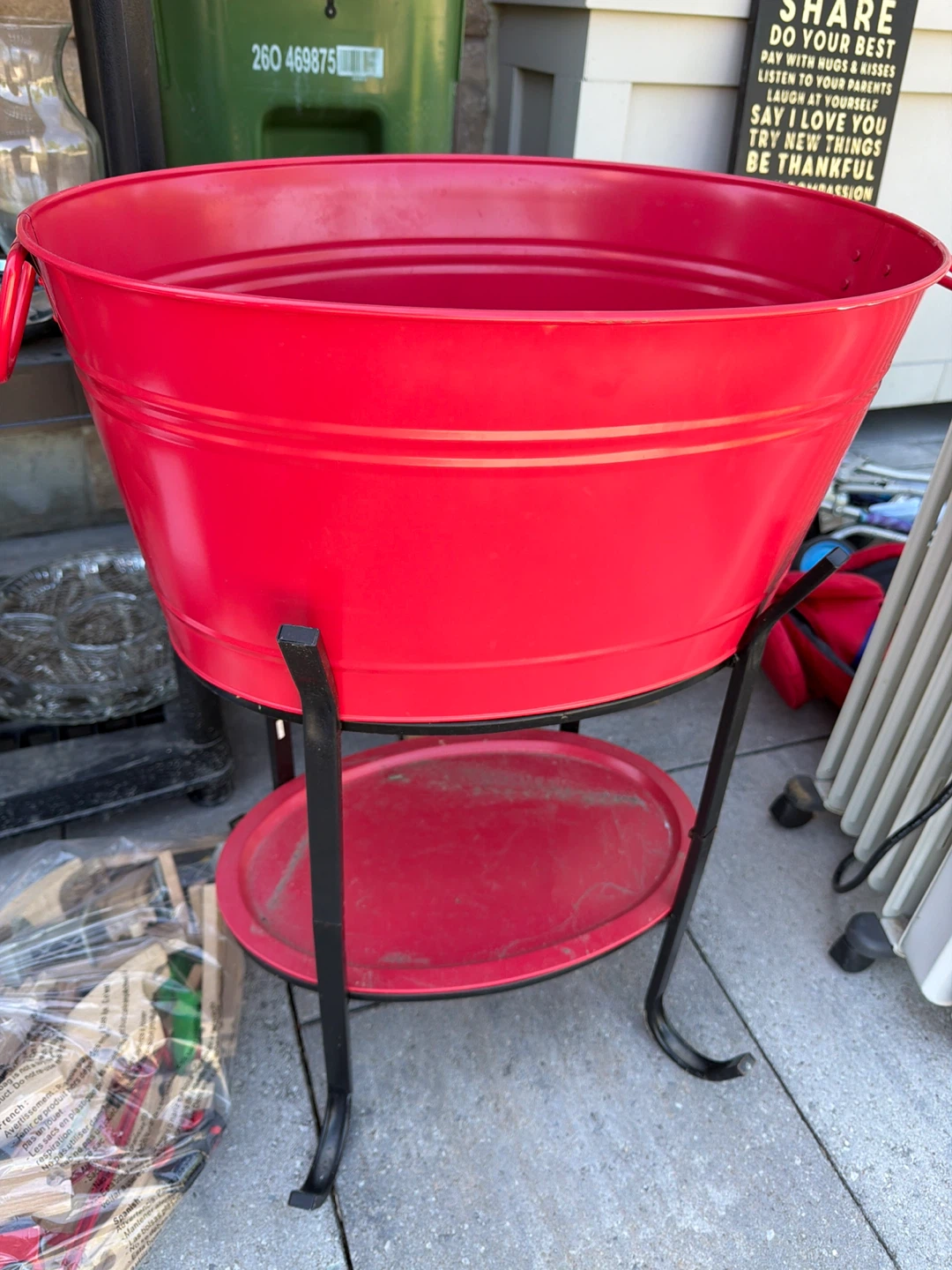 Red metal ice tub on stand