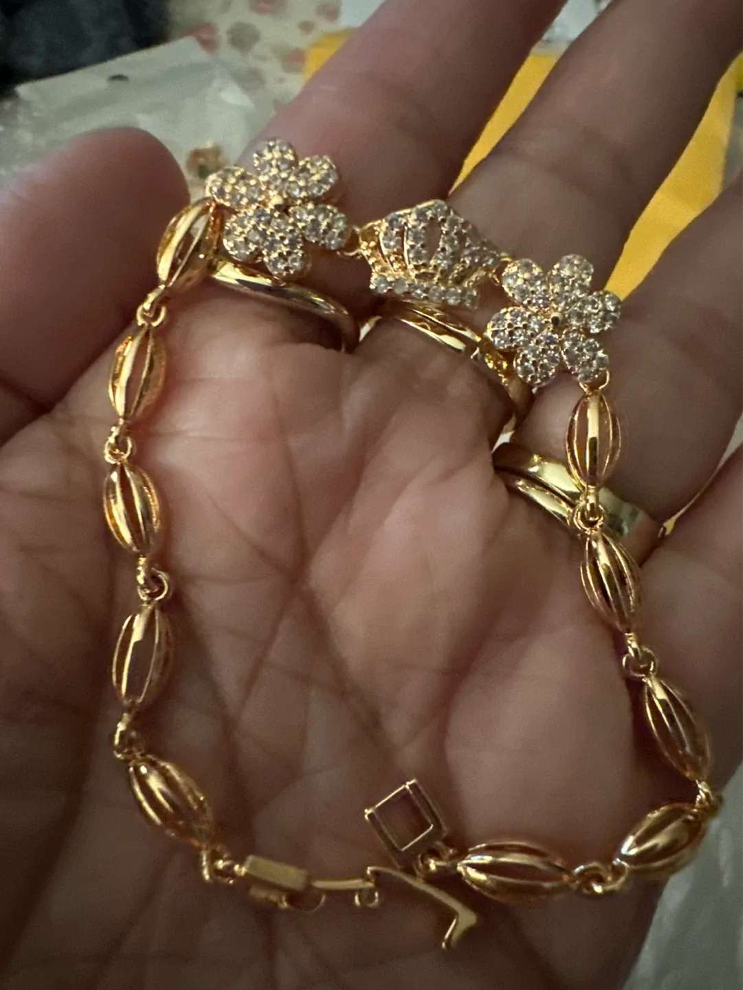 Gold-tone Bracelet with Flower and Crown Charms