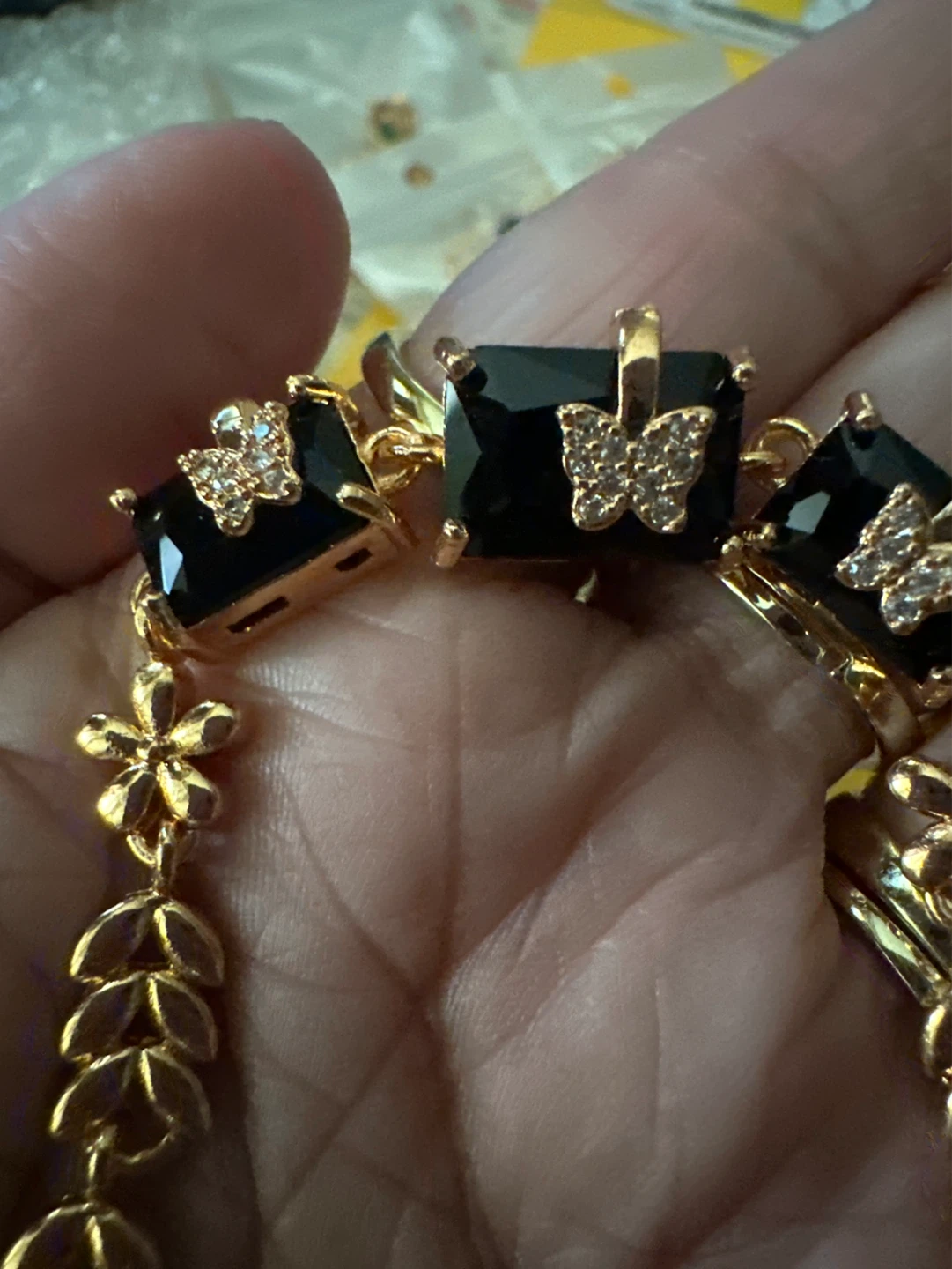 Gold tone bracelet with black square gems and butterfly accents - photo 2