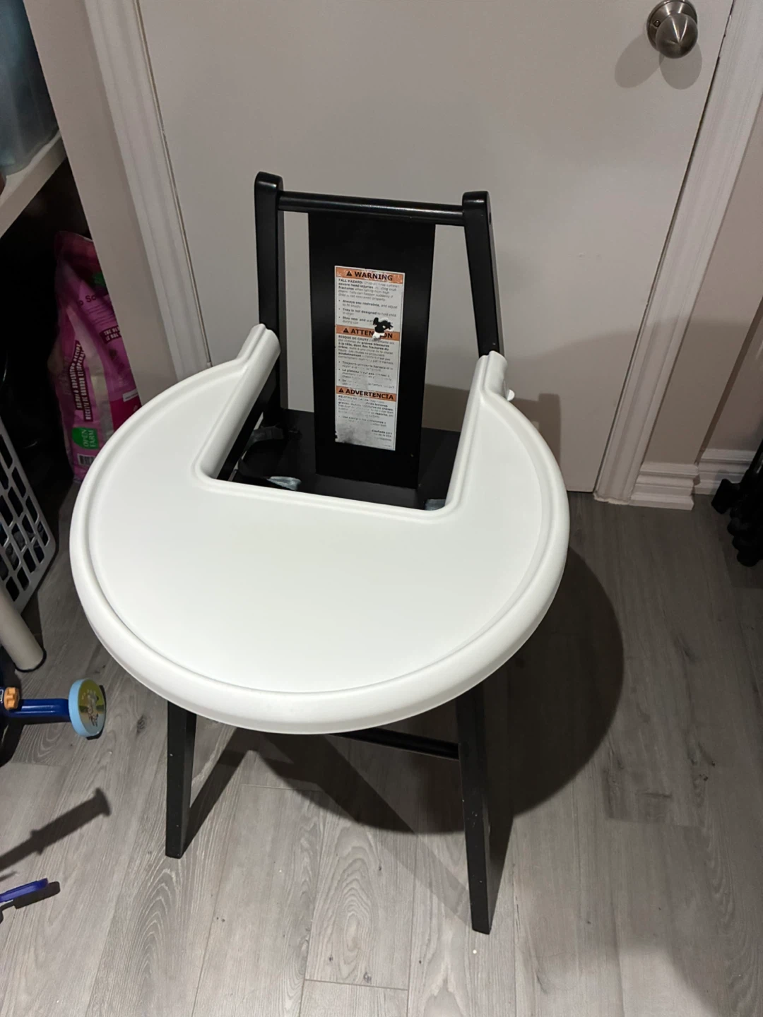 Black high chair with white tray