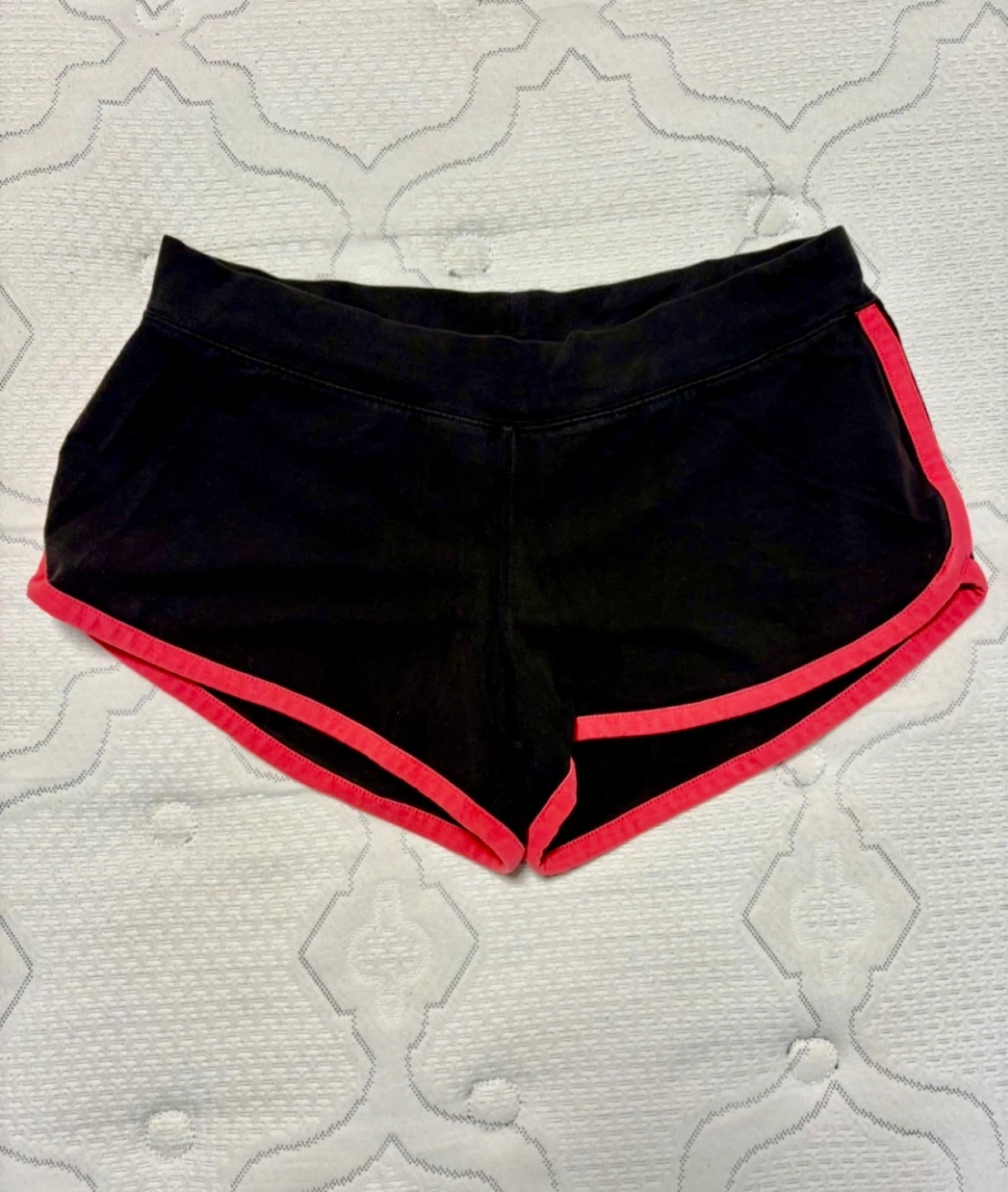 Black running shorts with pink trim