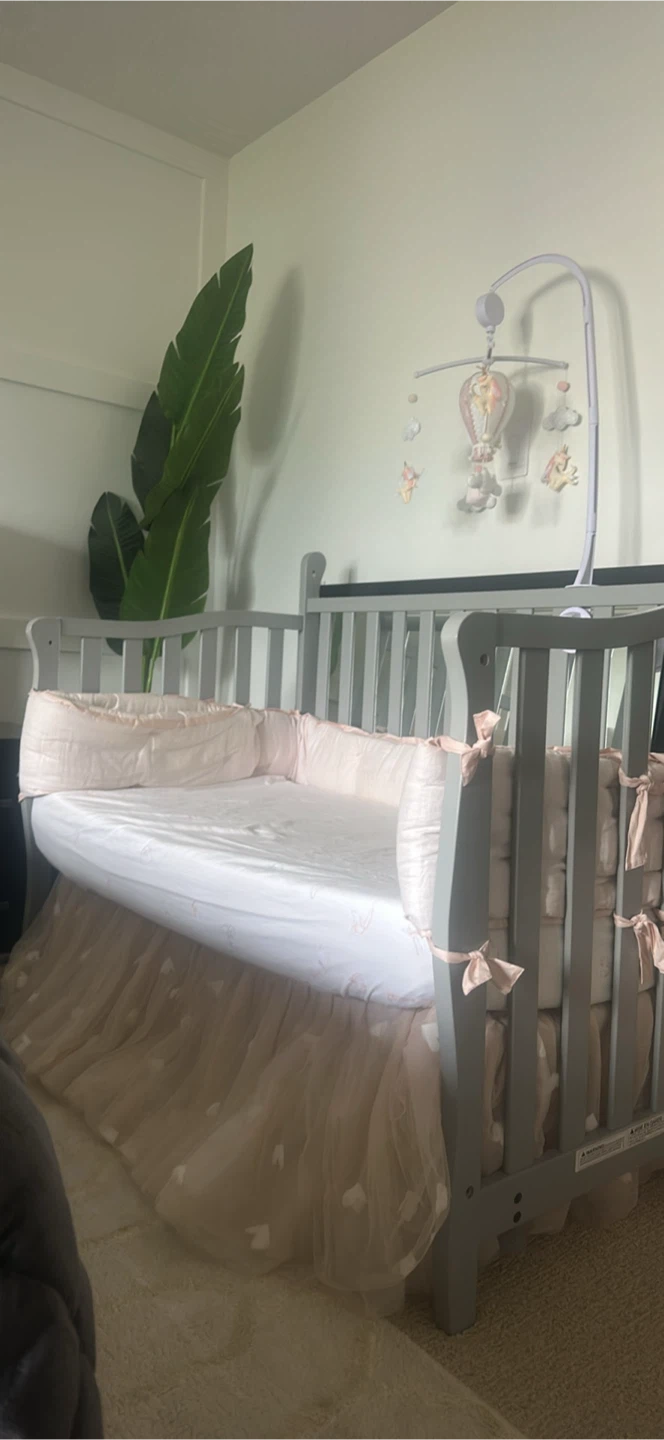 Grey Baby Crib with Pink Bedding