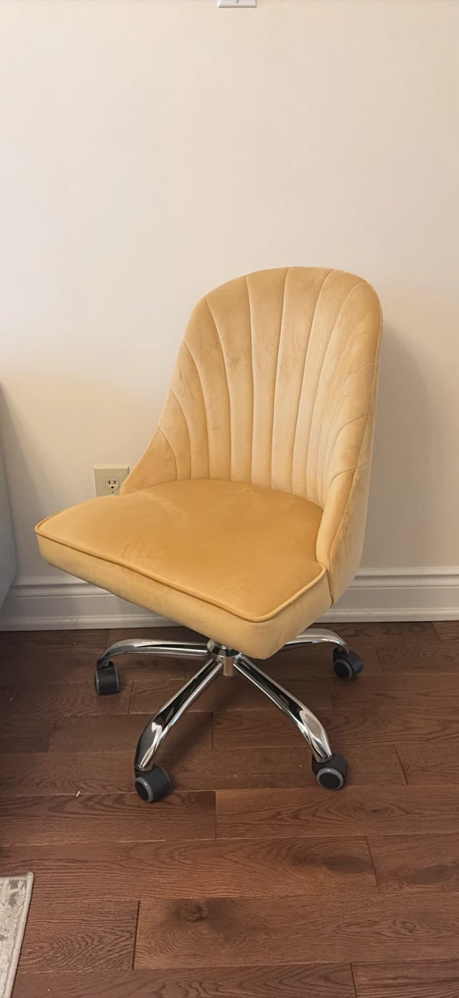 Yellow velvet desk chair on wheels