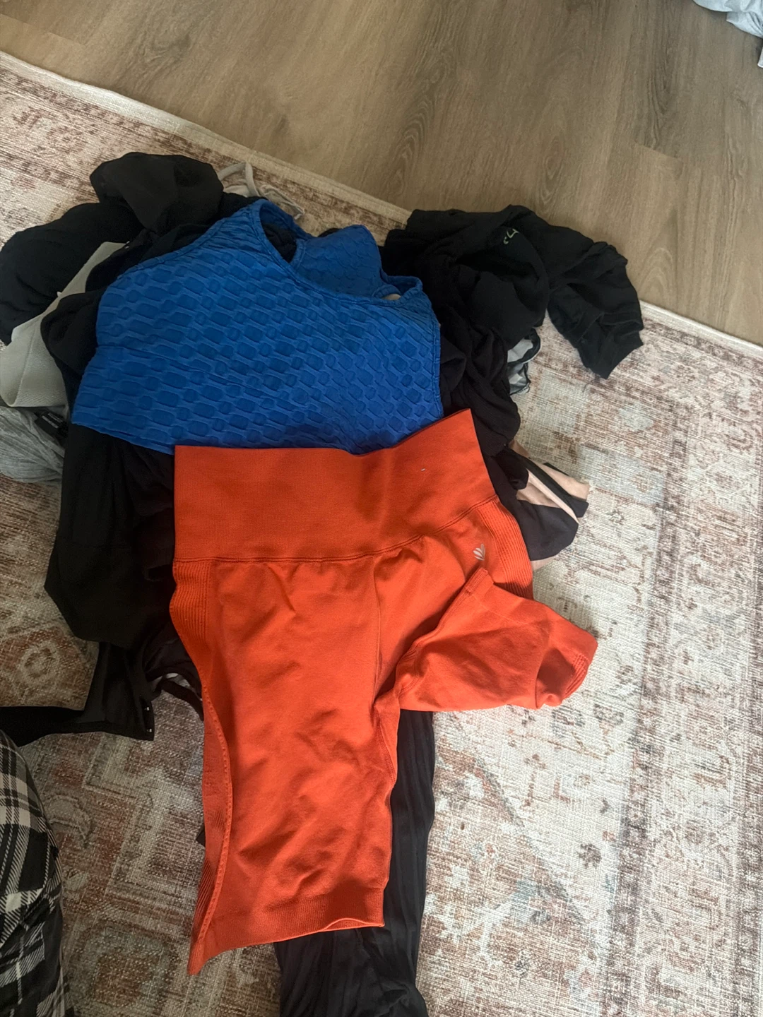 Blue textured sports bra and orange workout shorts