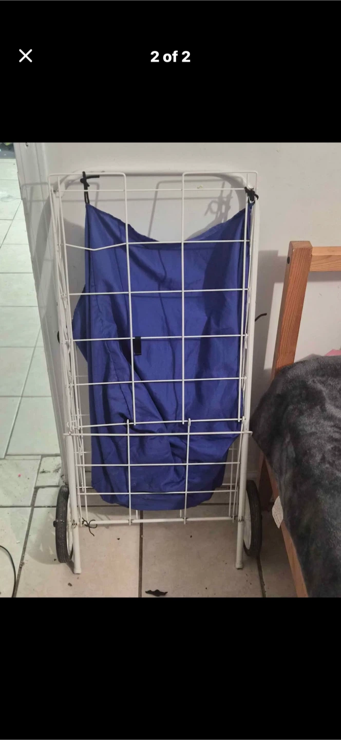 White wire shopping cart with blue bag