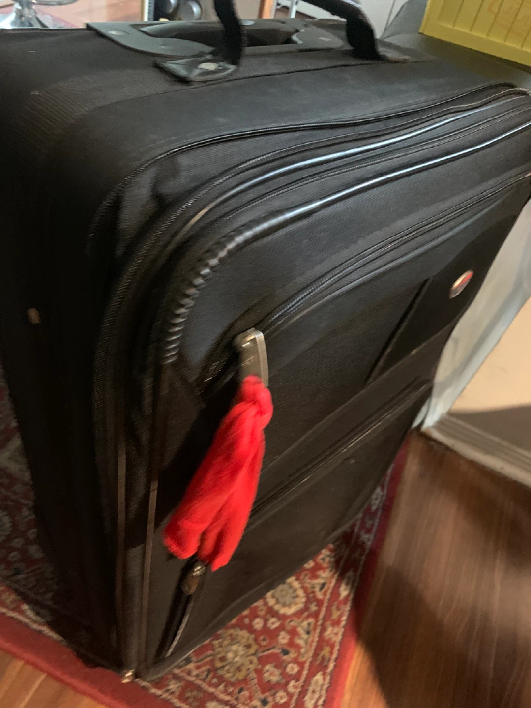 Black softside suitcase with red tassel charm - photo 2