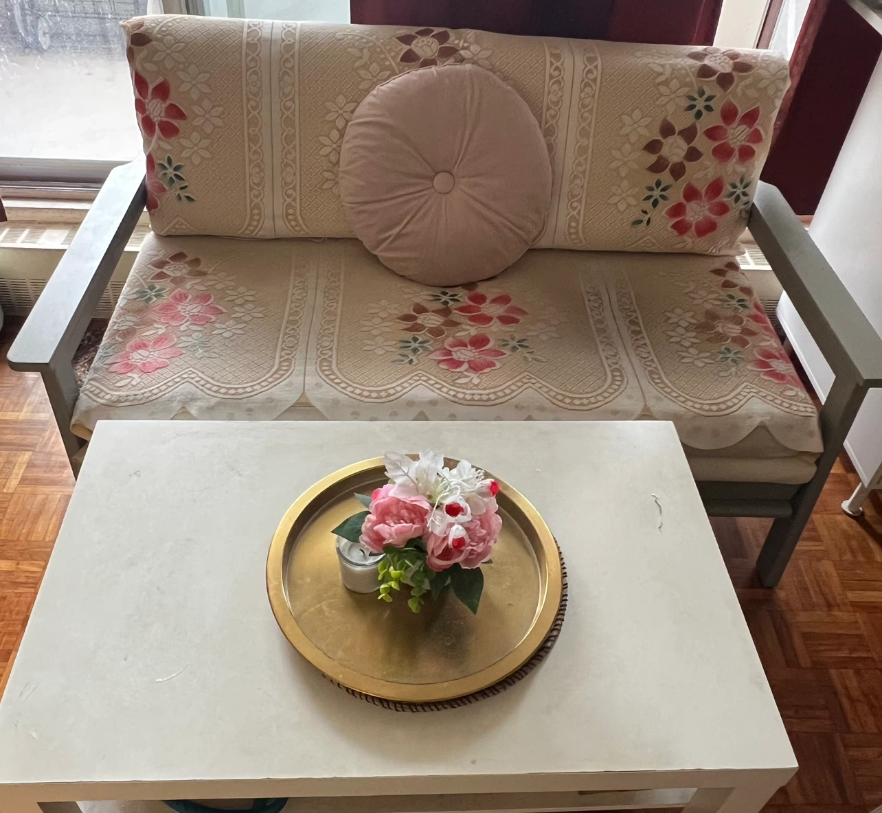Sofa with Floral Slipcover and a white tea table