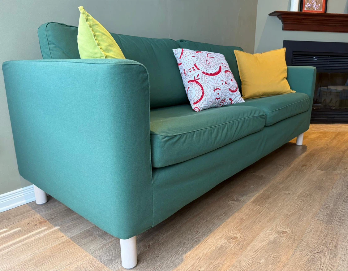 IKEA Green Two-Seater Sofa with White Legs