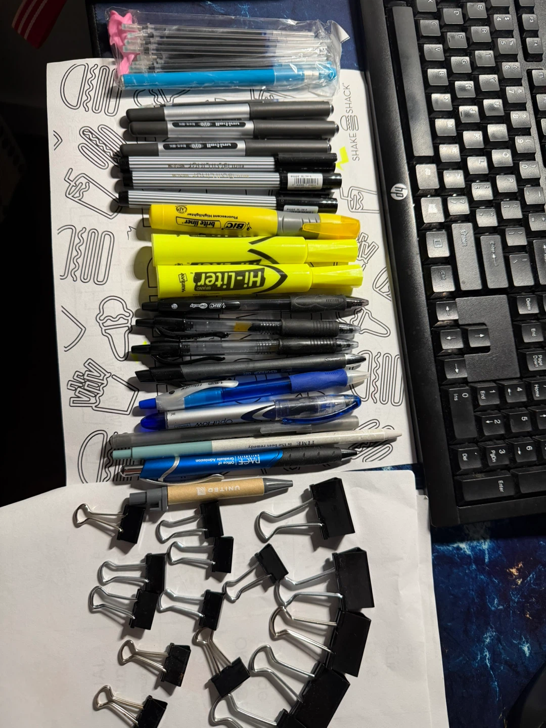 Assorted Pens, Highlighters, and Binder Clips