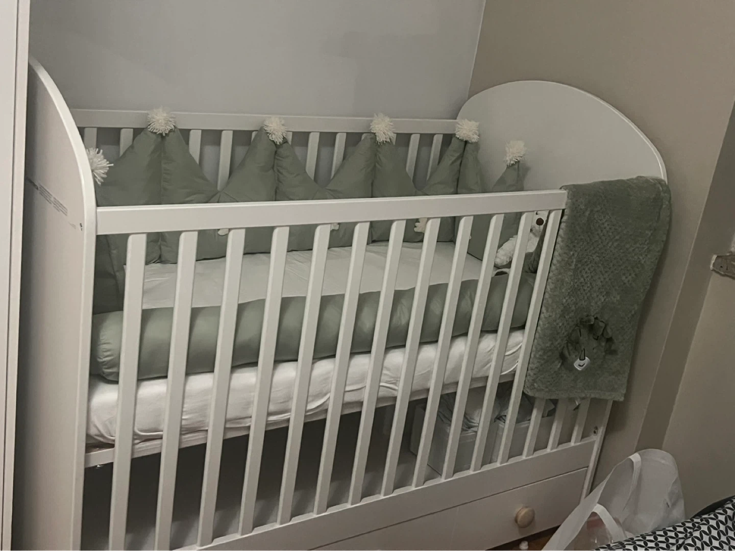 White baby crib with drawer