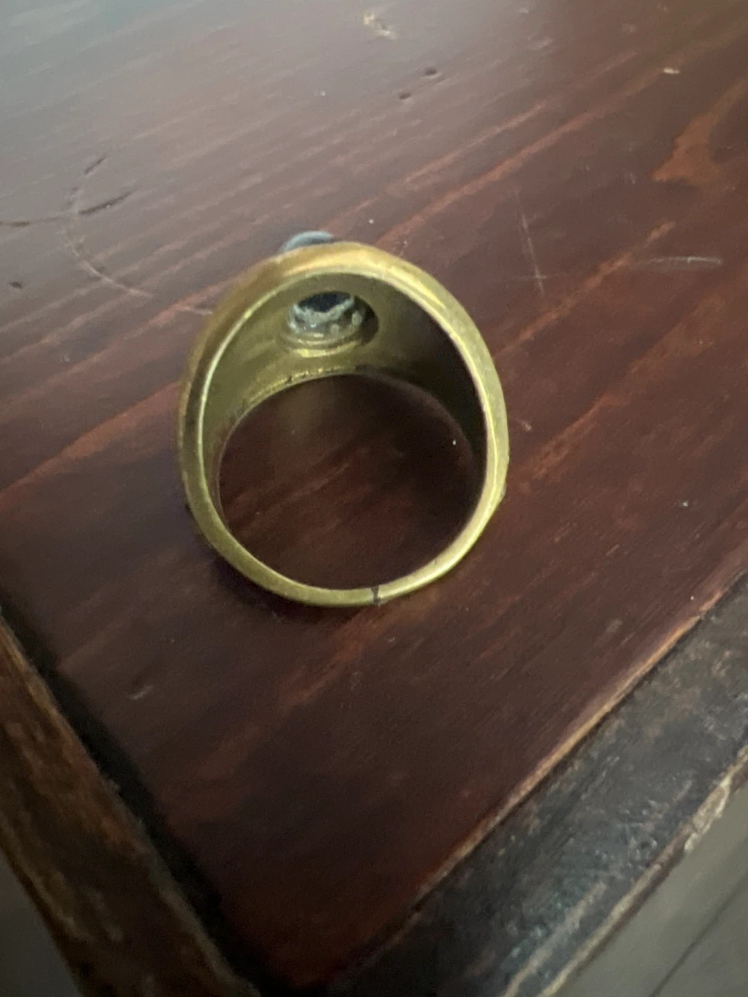 Gold tone ring with black stone