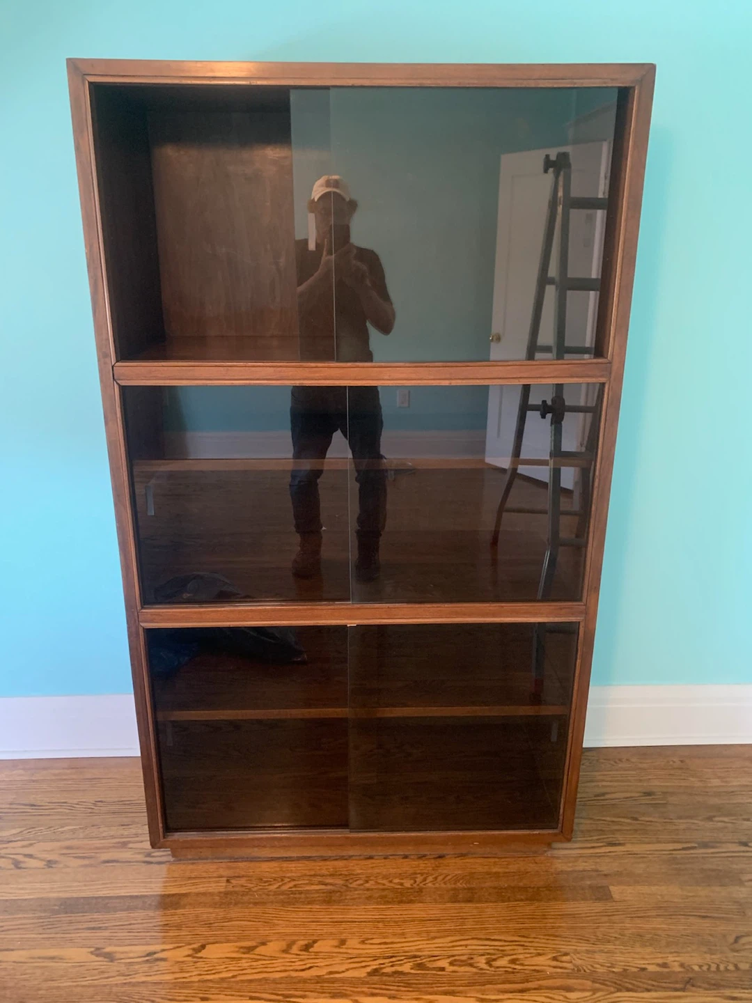 Wooden display cabinet with sliding glass doors