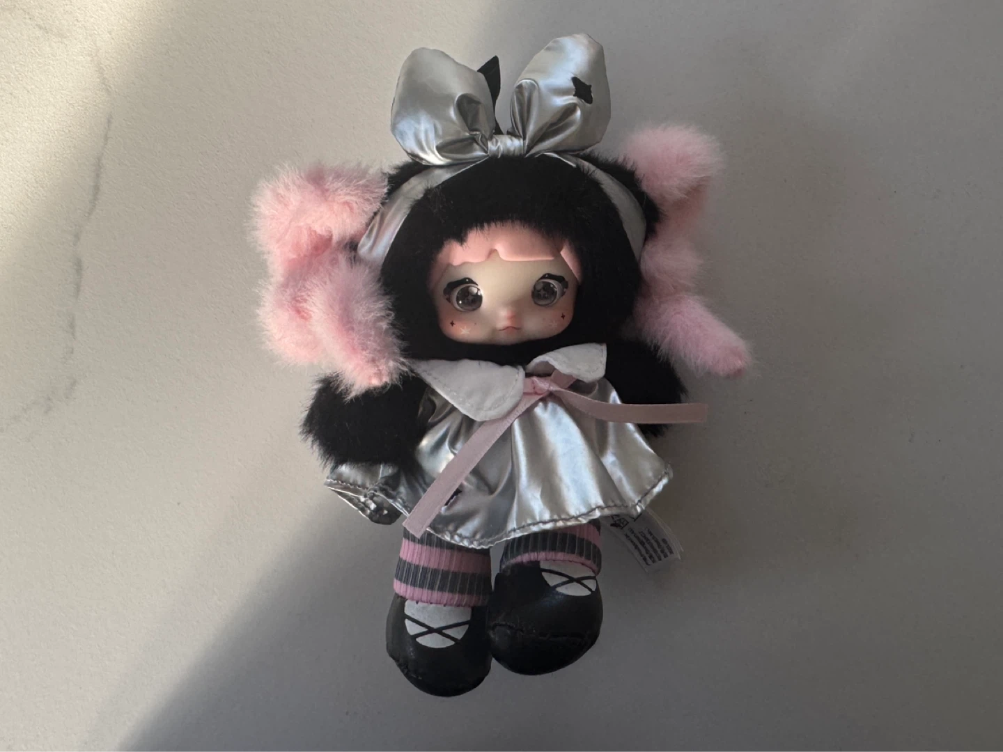Plush Doll with Black Fur Hood and Pink Accents