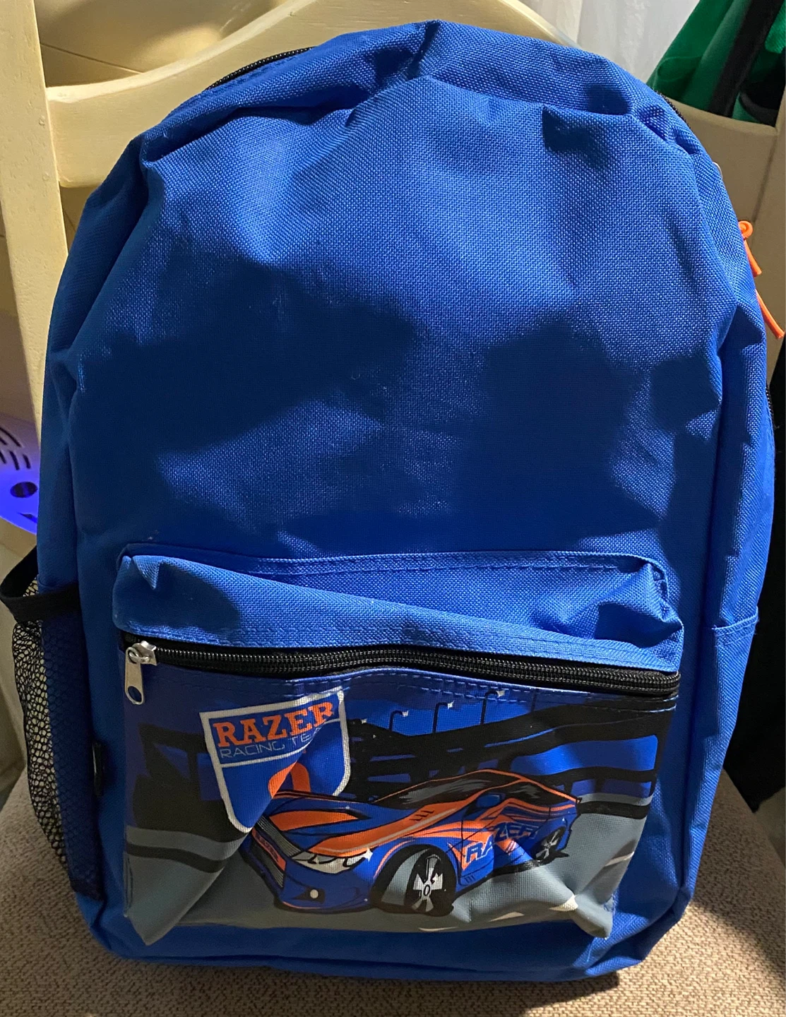 Blue backpack with race car graphic
