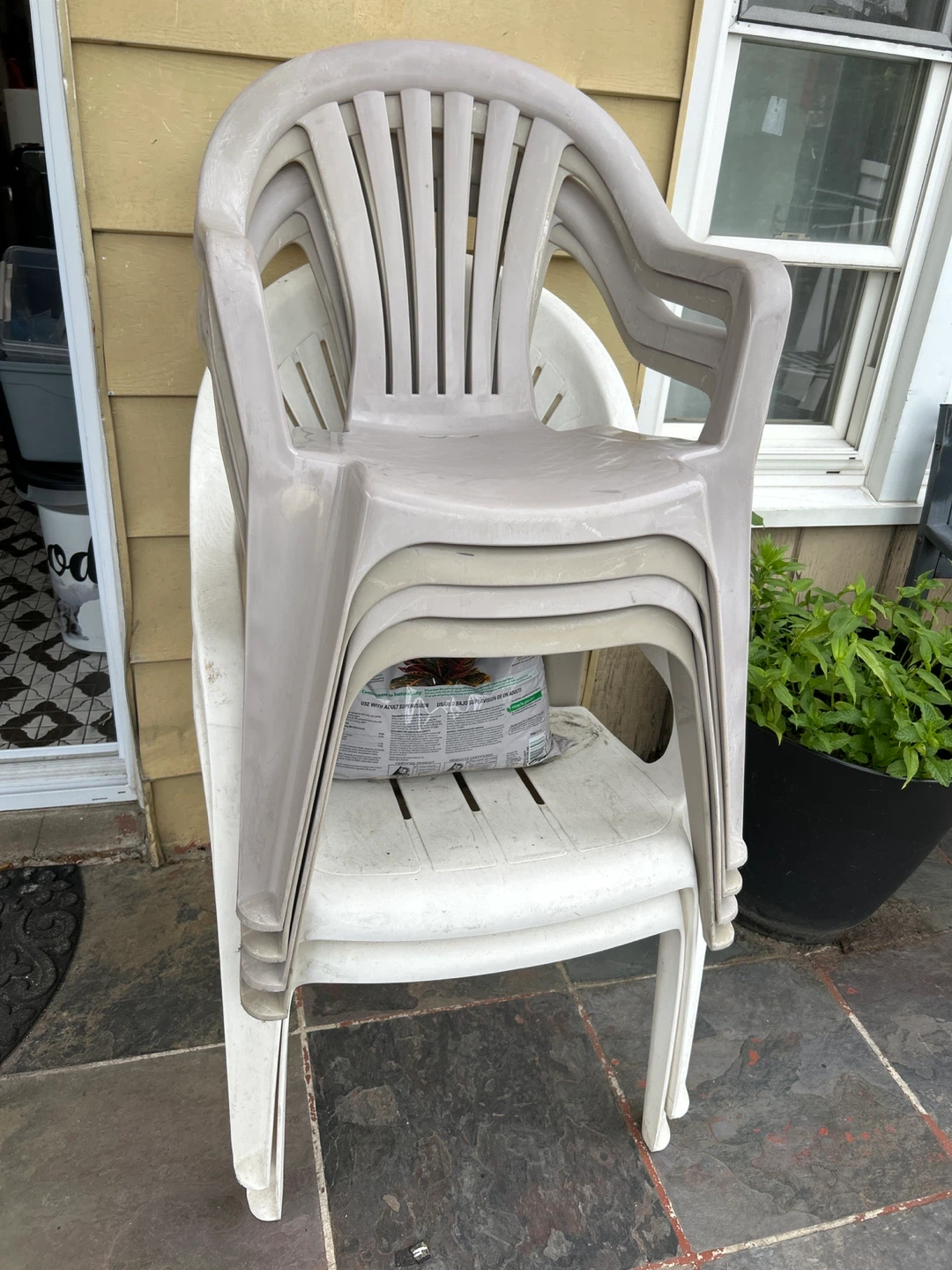 Stack of 6 plastic patio chairs