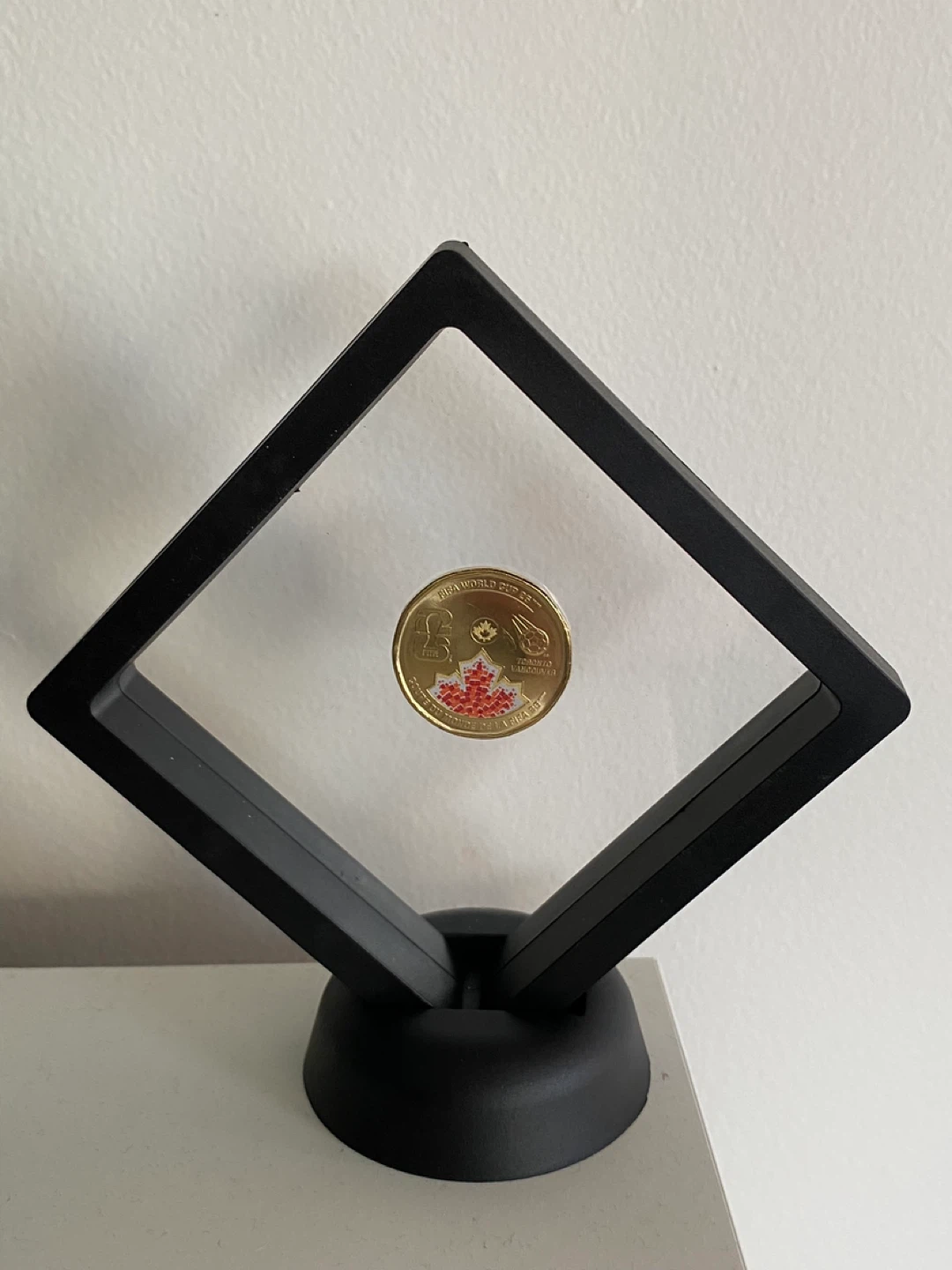 FIFA $1 Loonie in a display case