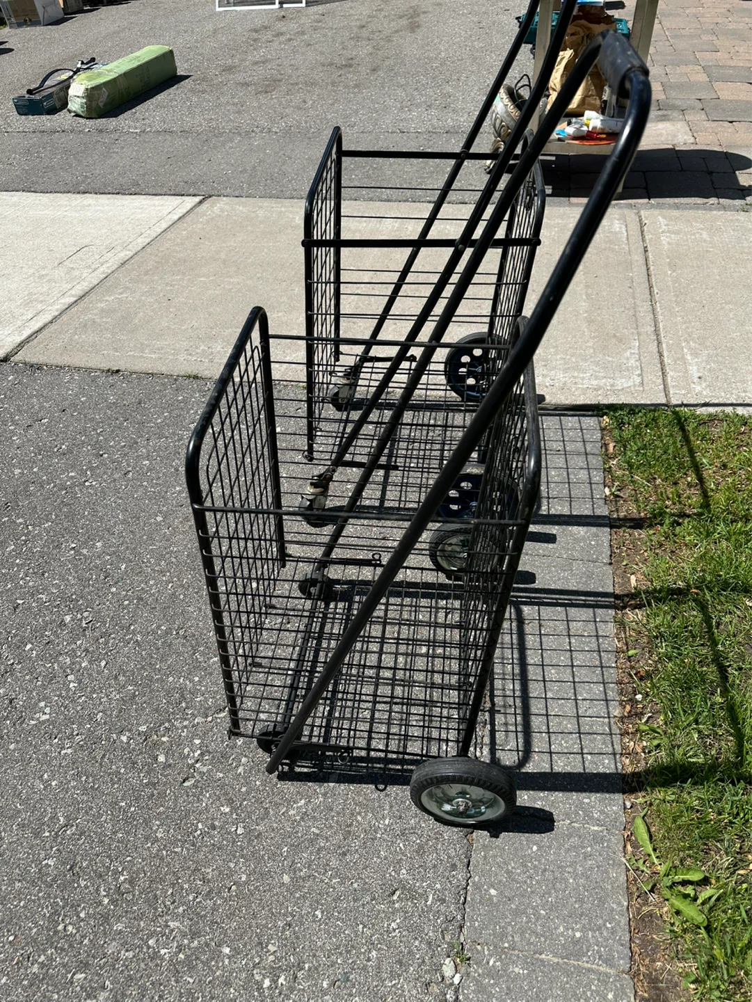 Two Black Metal Shopping Carts