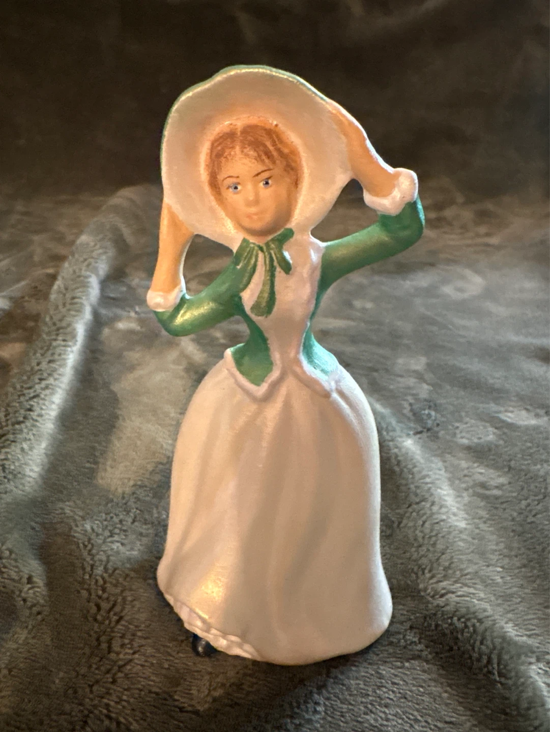 Figurine of a woman in a green and white dress