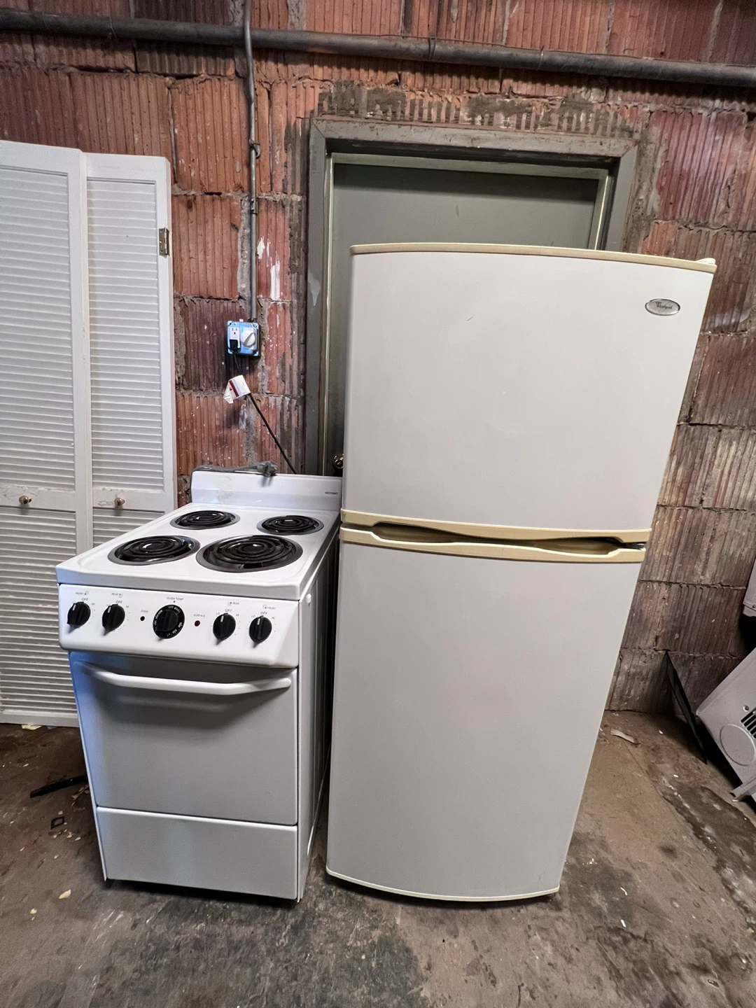 White Whirlpool Refrigerator and Hotpoint Stove