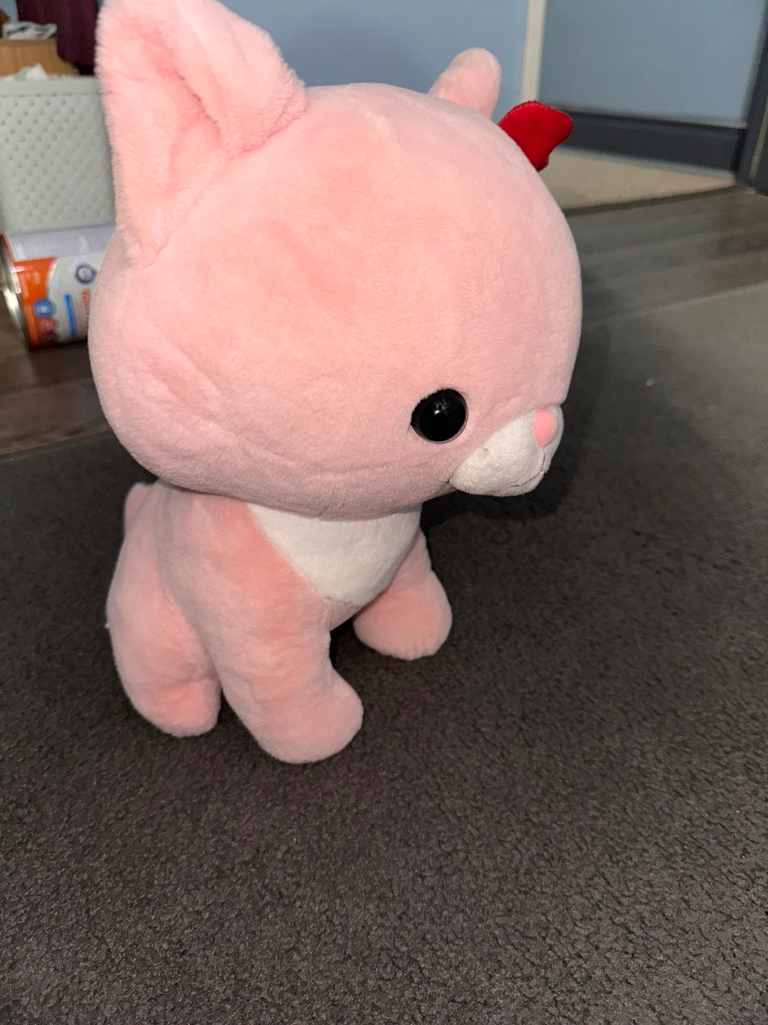 Pink plush cat with red bow