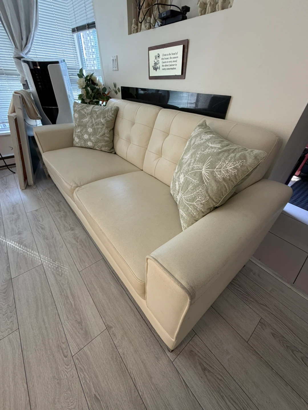Cream coloured sofa with throw pillows