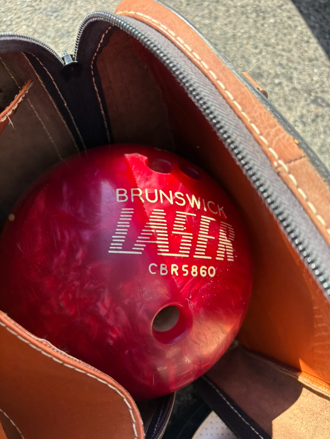 Brunswick bowling ball set with antique leather bag