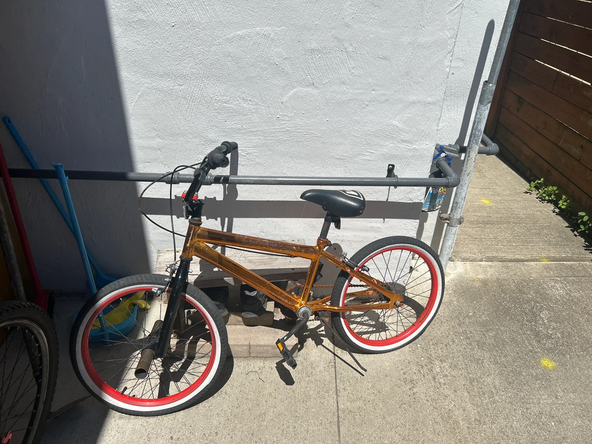 Gold BMX Bike with Red and White Rims