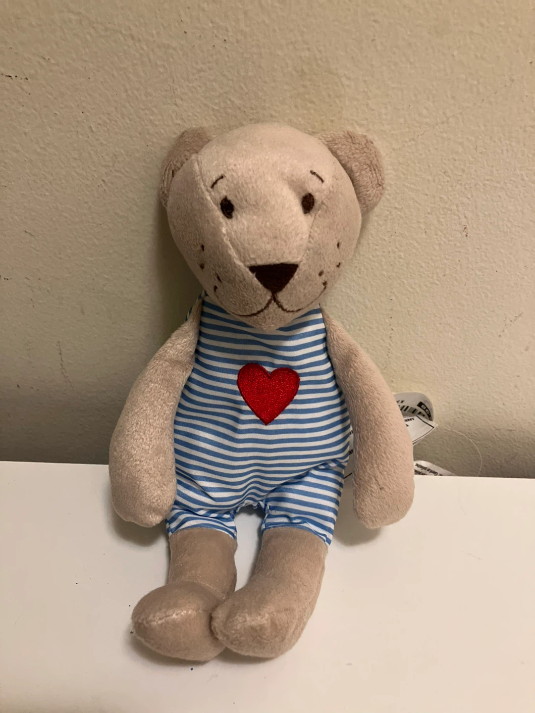 Plush Teddy Bear with Striped Outfit and Red Heart