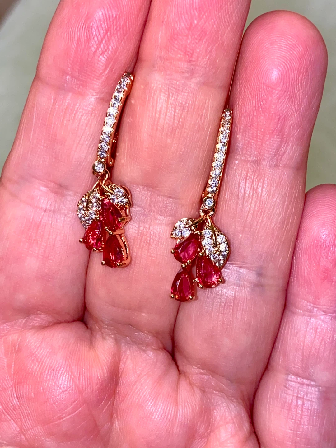 Rose Gold Tone Dangle Earrings with Red Stones