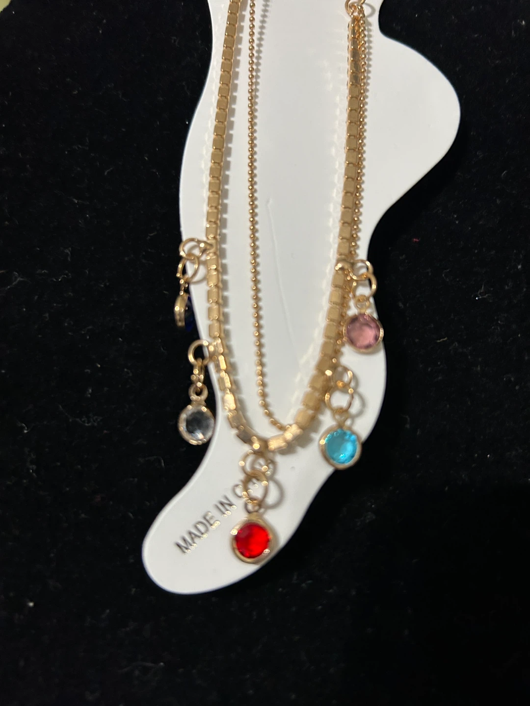 Gold tone layered ankle bracelet with colorful charms