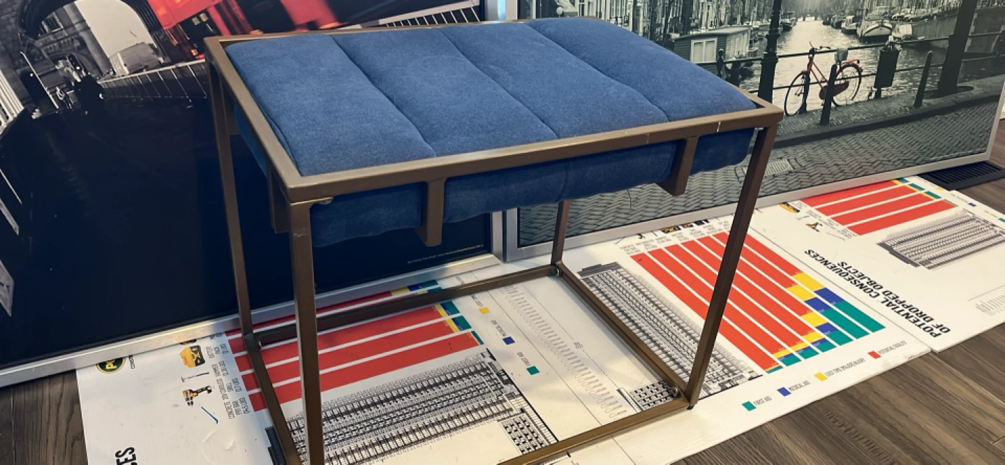 Blue upholstered stool with gold frame
