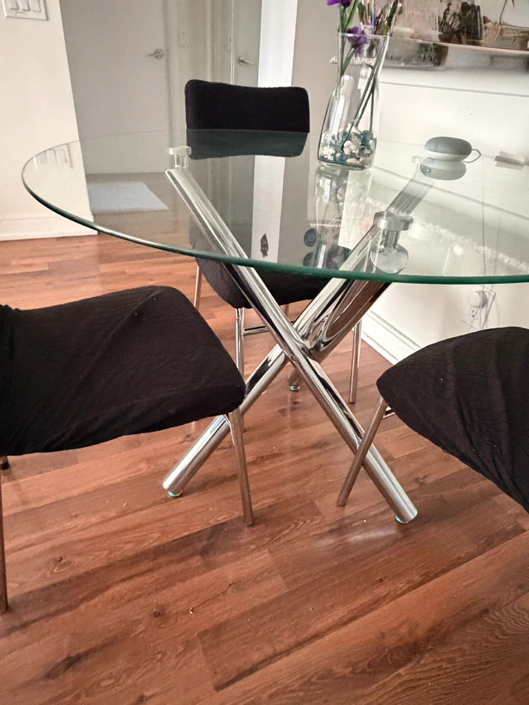 Glass Dining Table with 4 Black Chair Covers