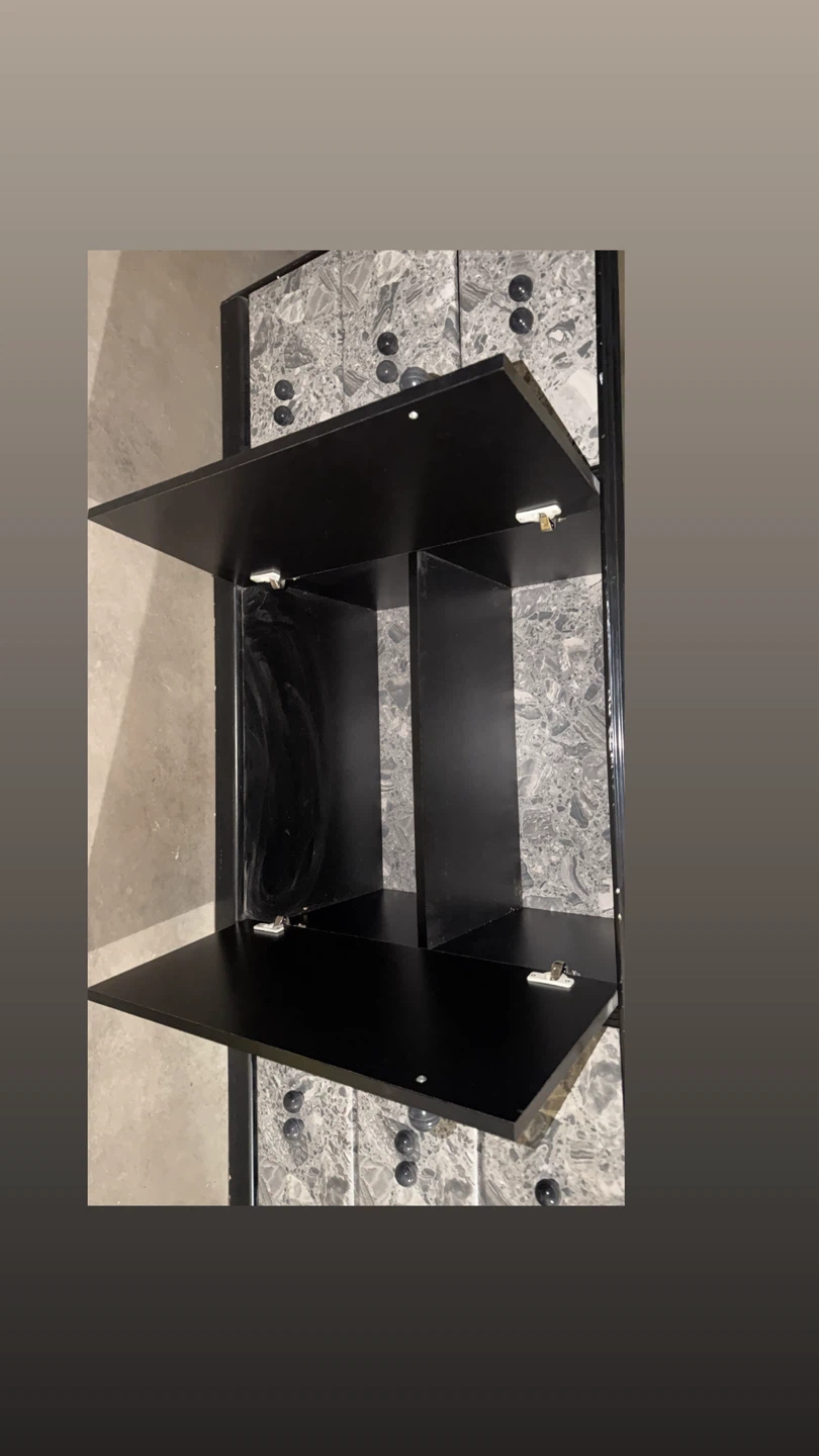 Black dresser with faux marble drawer fronts and bedside tables