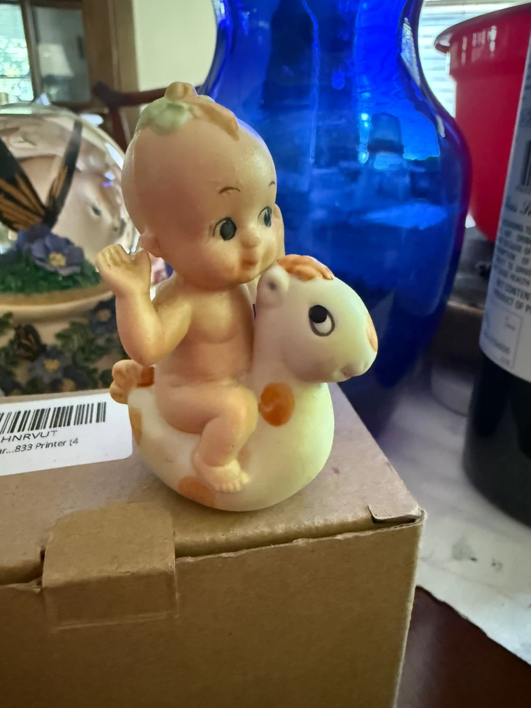 Vintage Kewpie Doll riding a rocking horse figurine