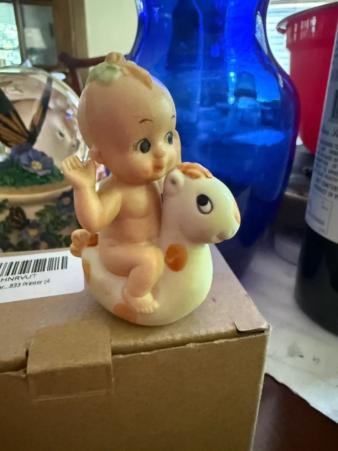 Vintage Kewpie Doll riding a rocking horse figurine