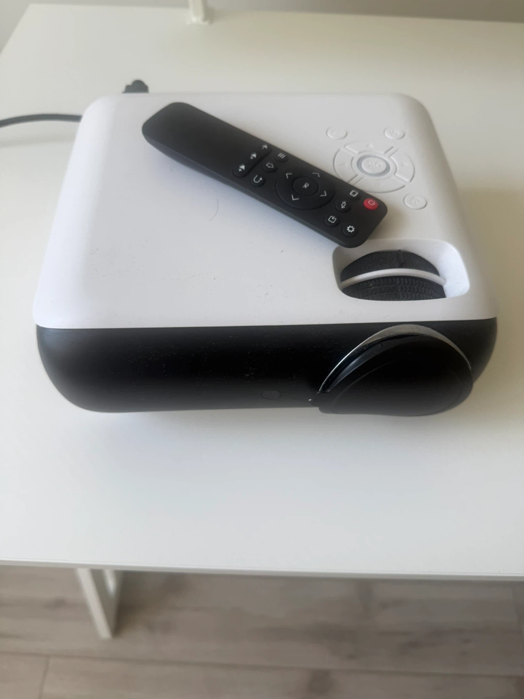 White portable projector with remote