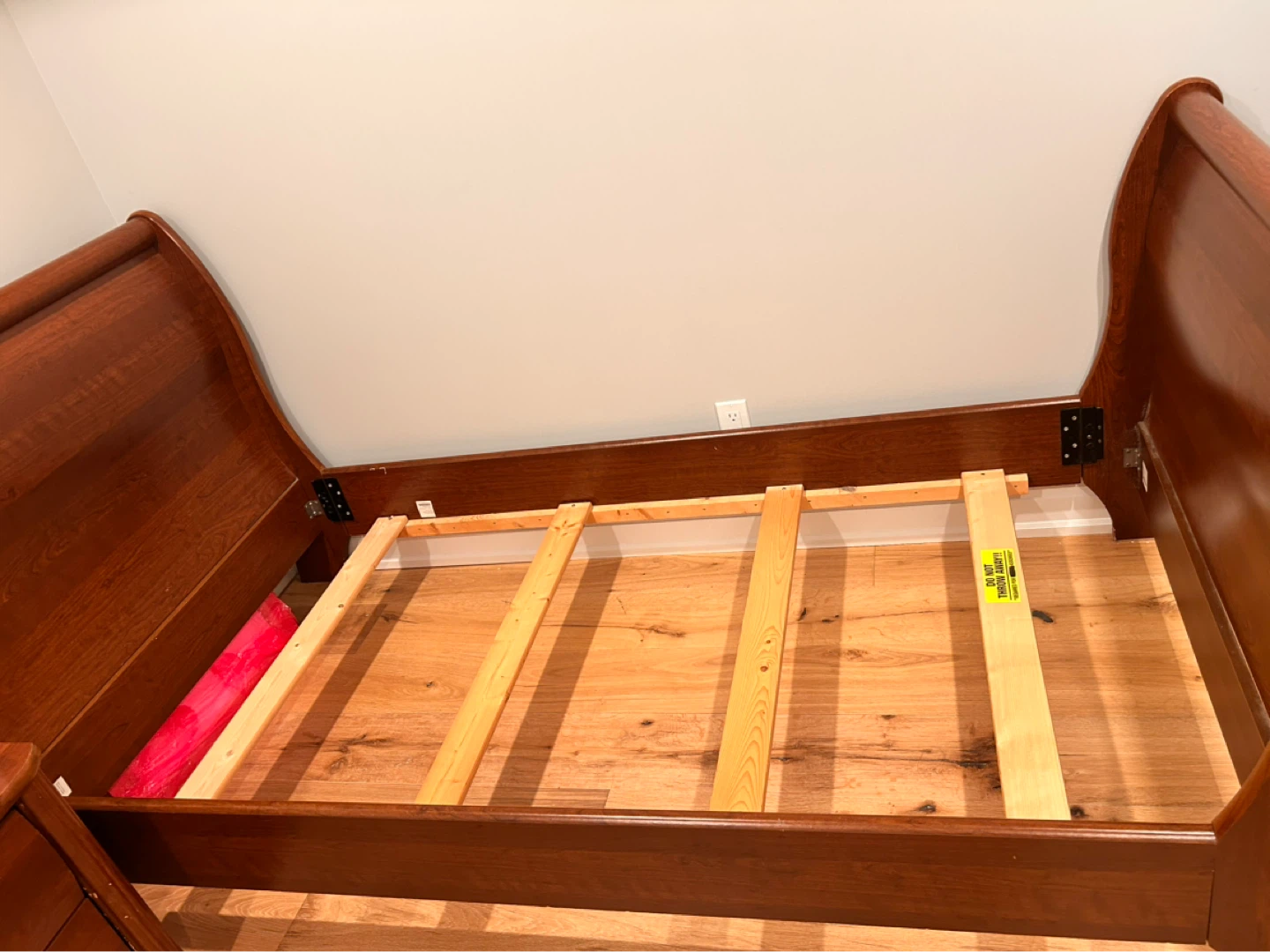 Classic twin-sized sleigh bed frame, mattress and box spring.