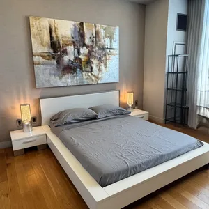 Modern White Platform Bed Frame with Gray Bedding