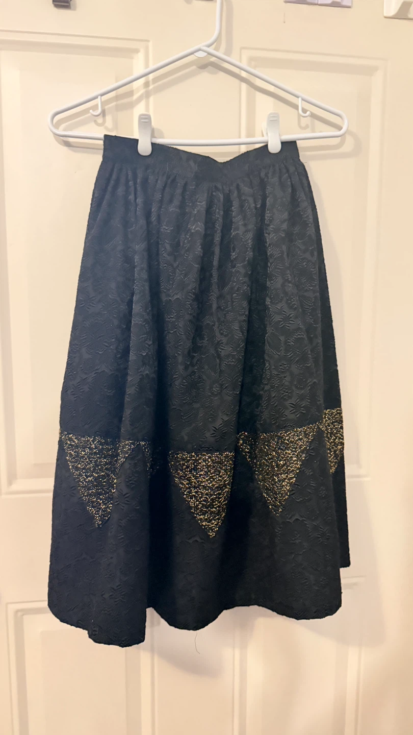 Black A-line skirt with gold trim. Size 5-6
