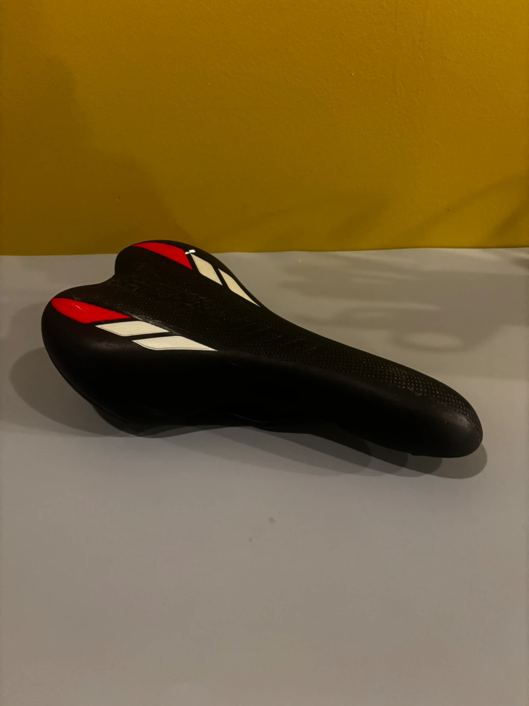 Black Bicycle Saddle with Red and White Accents